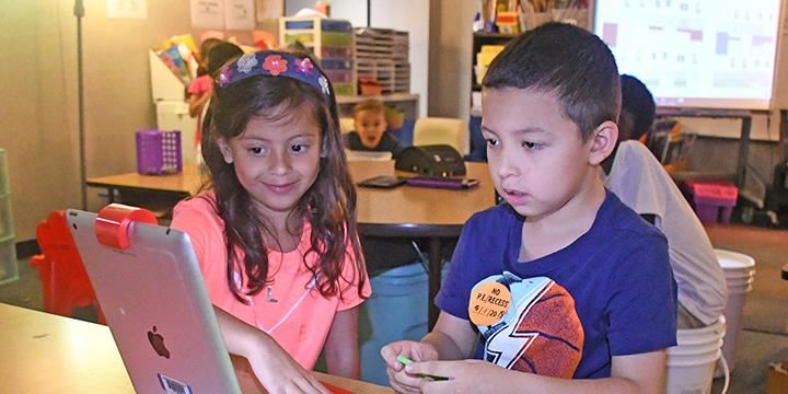 Bang Elementary School kindergarten students Callie Romero, left, and Isaac Garcia play Osmo on a cl