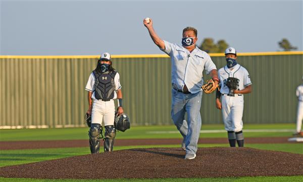 Trustee Gilbert Sarabia throwing the first pitch at a baseball game